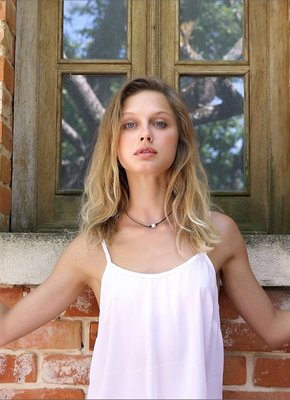 Худенькая девица на фоне кирпичной стены